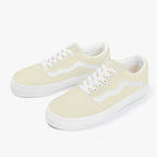 Pale yellow low-top canvas sneakers with white laces and white rubber soles.