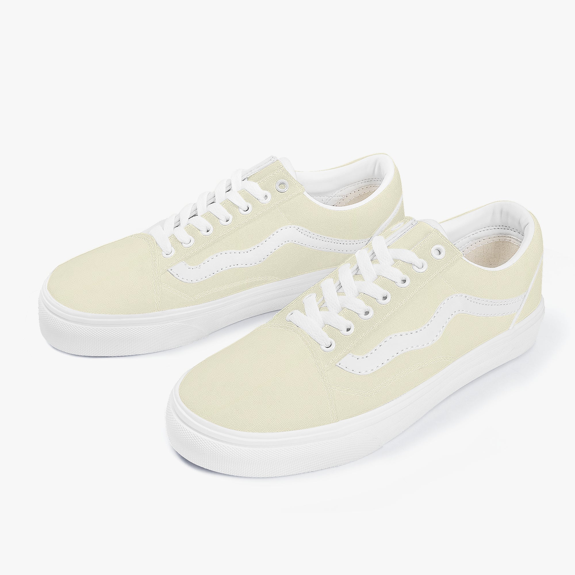 Pale yellow low-top canvas sneakers with white laces and white rubber soles.