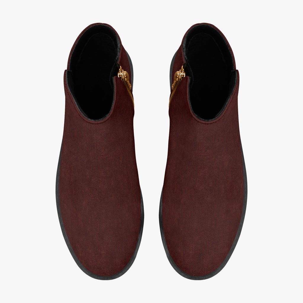 Burgundy corduroy ankle boots with chunky black heels and gold side zippers, top view.