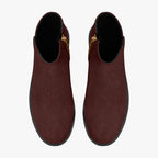 Burgundy corduroy ankle boots with chunky black heels and gold side zippers, top view.