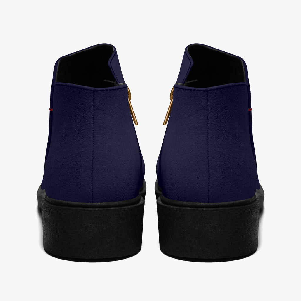 Navy blue slip-on booties with chunky black heels and red accent stitching, back view.