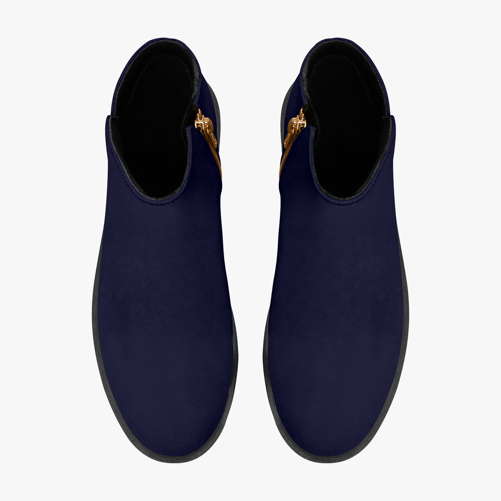 Navy blue slip-on booties with chunky black heels and red accent stitching on side zippers.