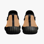 Beige knit low-top sneakers with black heel tab and textured black sole, rear view.