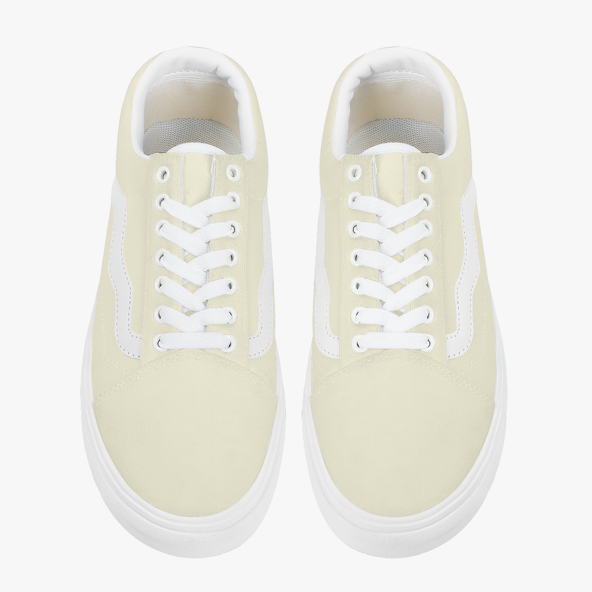 Pale yellow low-top canvas sneakers with white laces and thick white rubber soles.