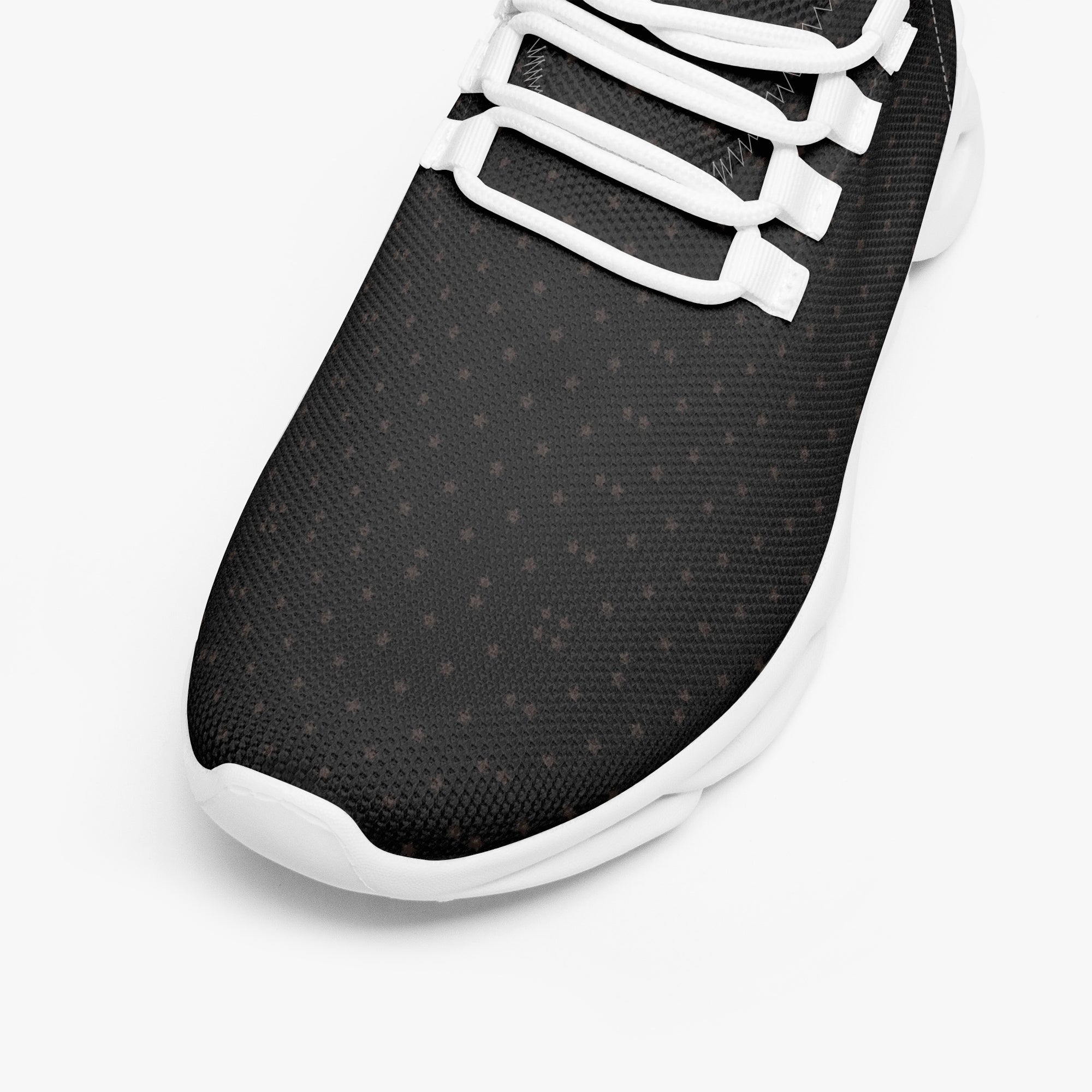 Black speckled knit sneaker toe with white mesh laces and white rubber sole.
