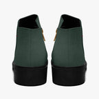 Dark green textured ankle boots with chunky black heels and gold side zippers, viewed from the back.