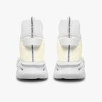 White high-top knit sneakers with thick soles and rear pull tabs, shown from the back.