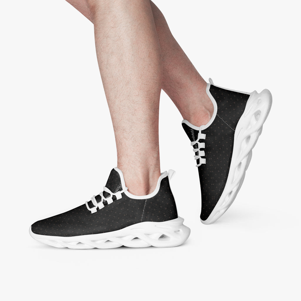 Black speckled knit sneakers with white cushioned sole and slip-on design.