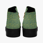 Teal ankle boots with sunny yellow polka dots, chunky black heels, and side zippers, rear view.