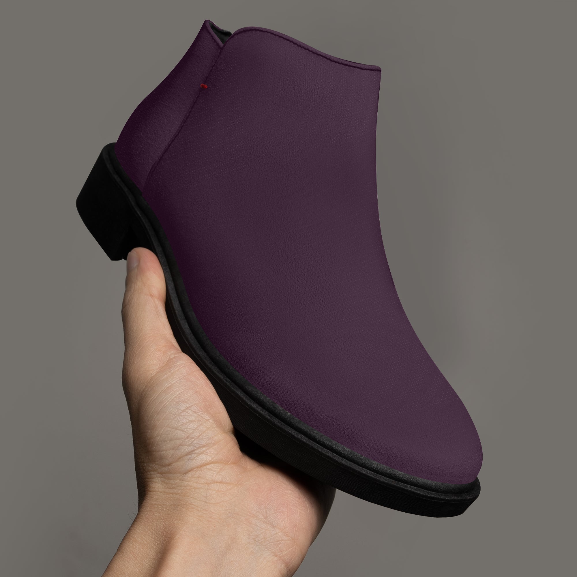 Deep plum slip-on bootie with chunky black heel and subtle red accent stitching.