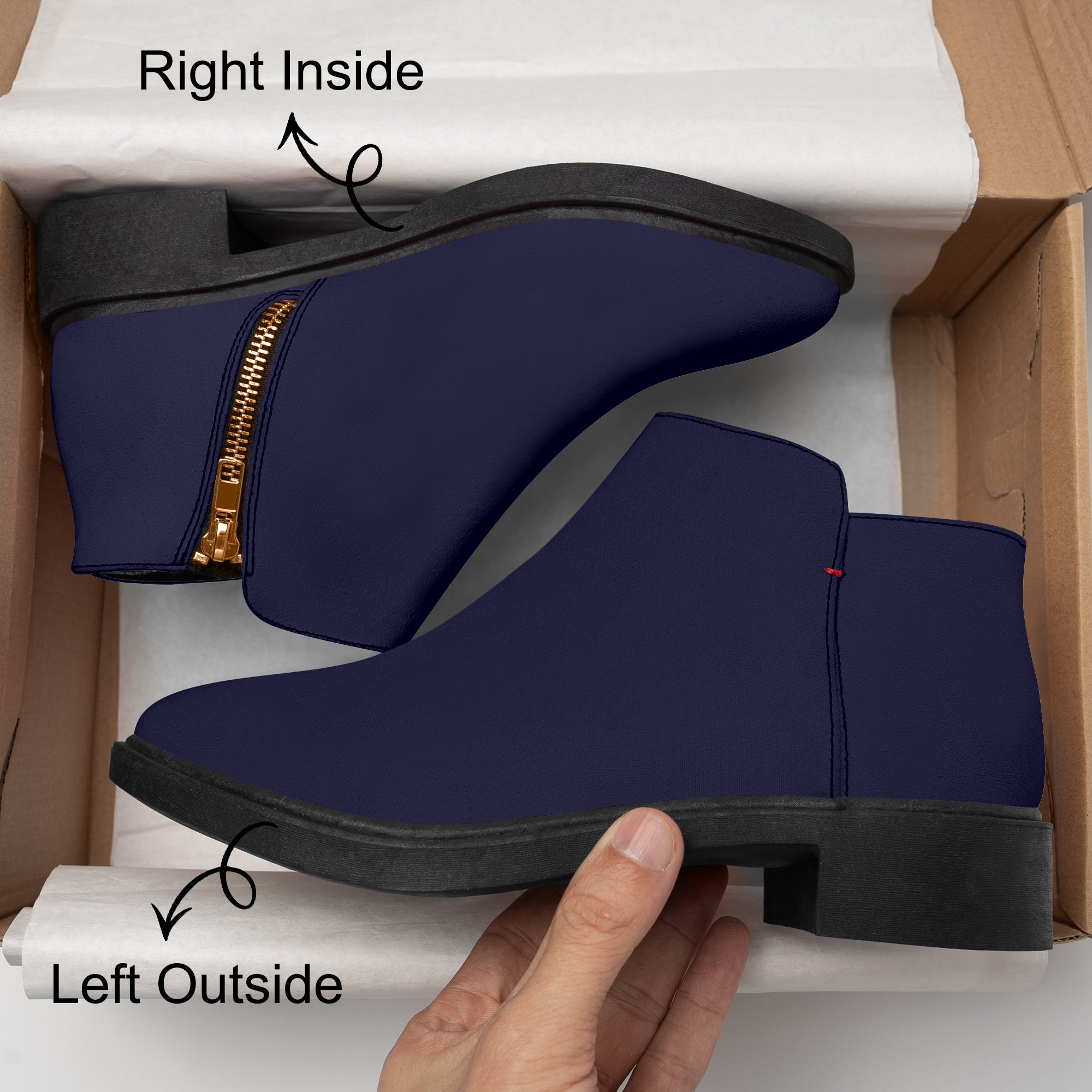 Navy blue slip-on bootie with chunky black heel, gold zipper, and red accent stitch.