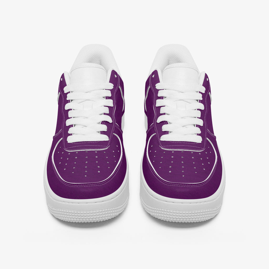 Pair of low-top sneakers with smooth purple leather upper, white laces, and thick white rubber soles.