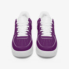 Pair of low-top sneakers with smooth purple leather upper, white laces, and thick white rubber soles.
