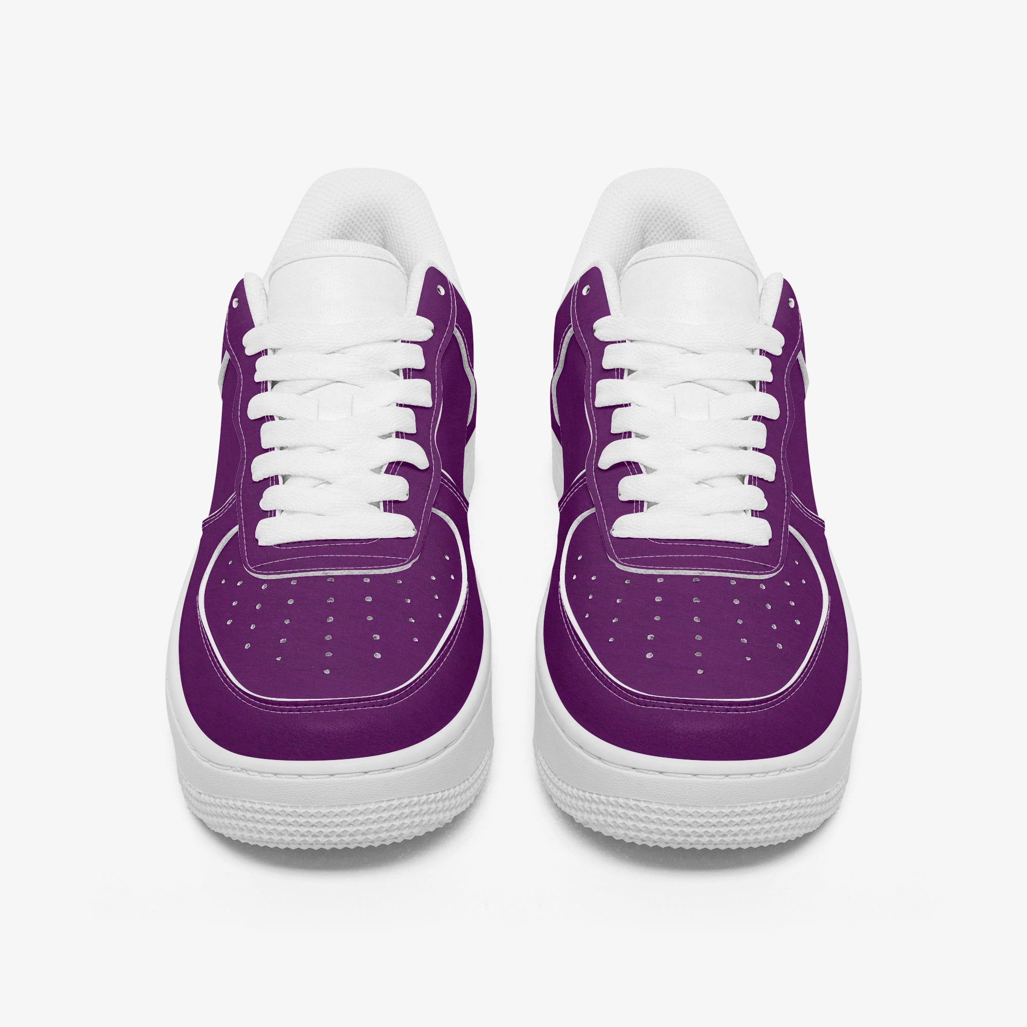 Pair of low-top sneakers with smooth purple leather upper, white laces, and thick white rubber soles.