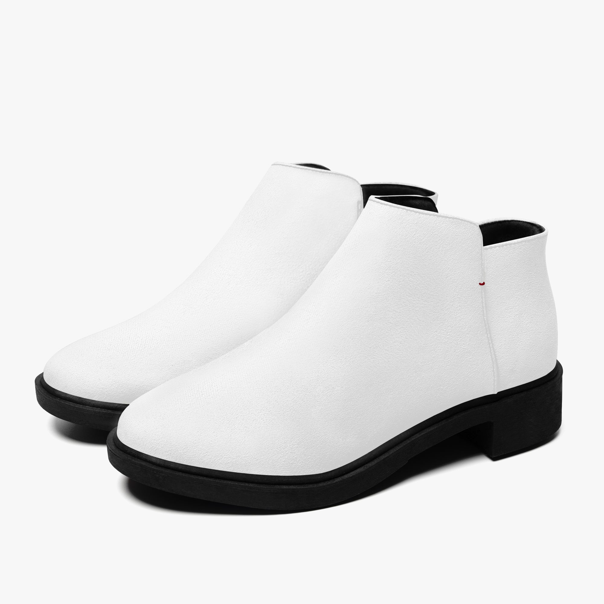 White slip-on ankle booties with chunky black heels and subtle red accent stitching.