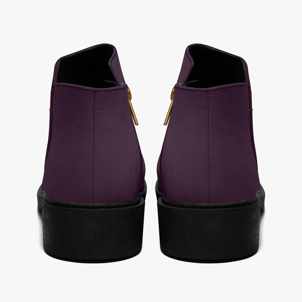 Deep plum slip-on booties with chunky black heels and gold zipper accents, rear view.
