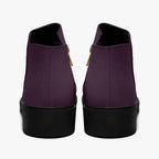 Deep plum slip-on booties with chunky black heels and gold zipper accents, rear view.