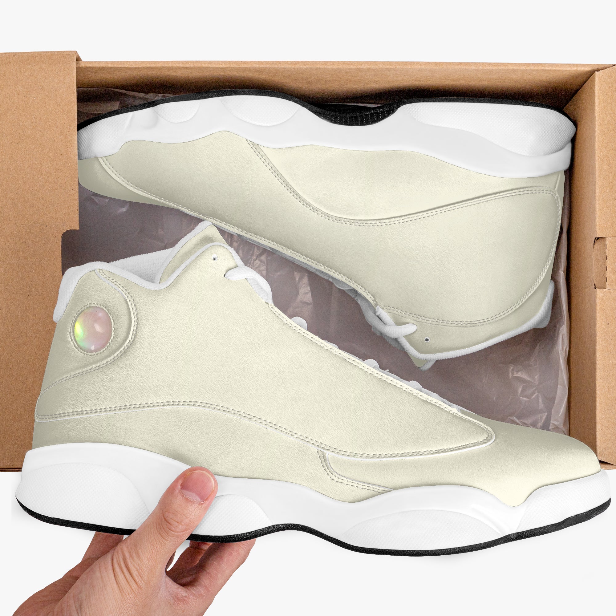 Cream and white high-top leather sneakers with translucent round logo and thick rubber sole in shoebox.