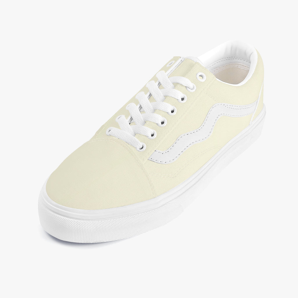 Pale yellow low-top canvas sneaker with white laces and contrasting white side stripe on white rubber sole.