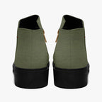 Olive green textured ankle boots with chunky black heels and rear gold zipper detail.