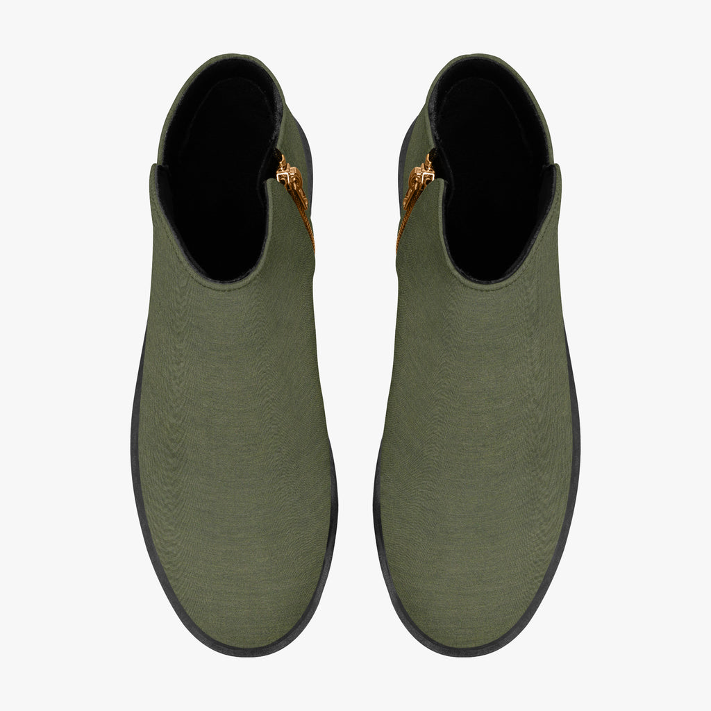 Olive green textured ankle boots with chunky black heels and gold side zippers, top view.