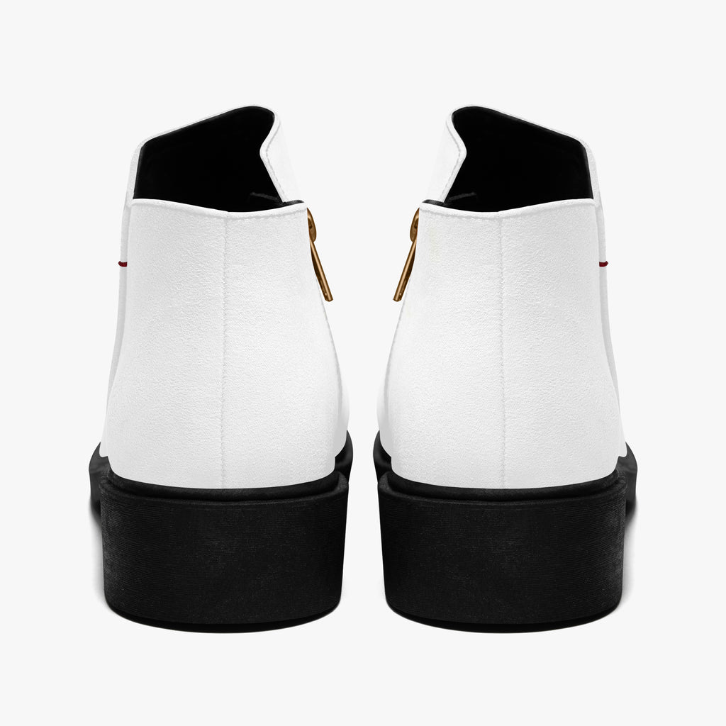 Pair of modern white slip-on booties with chunky black heels and red accent stitching viewed from the back.