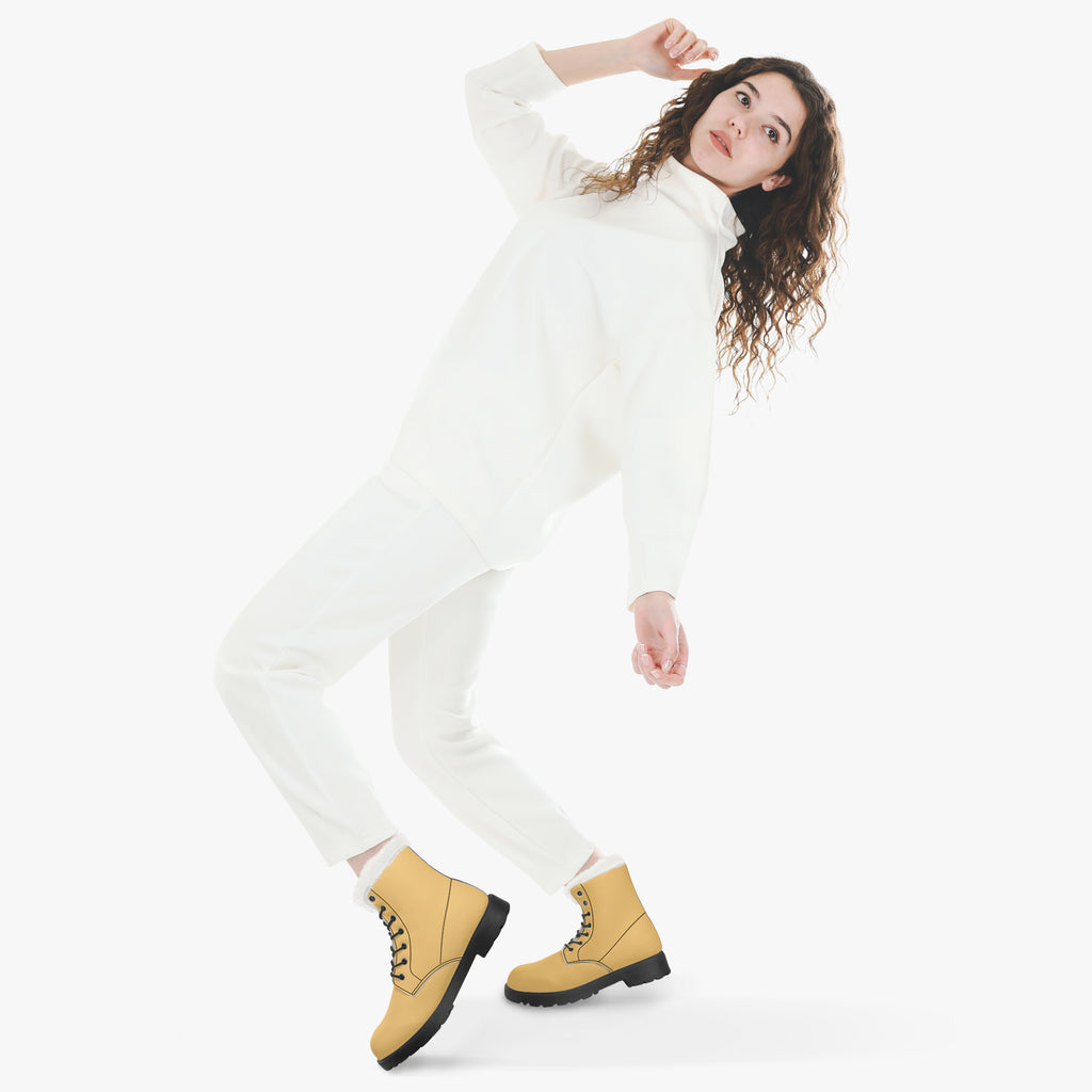 Sunny mustard lace-up leather winter boots with plush white faux fur collar worn with white outfit.