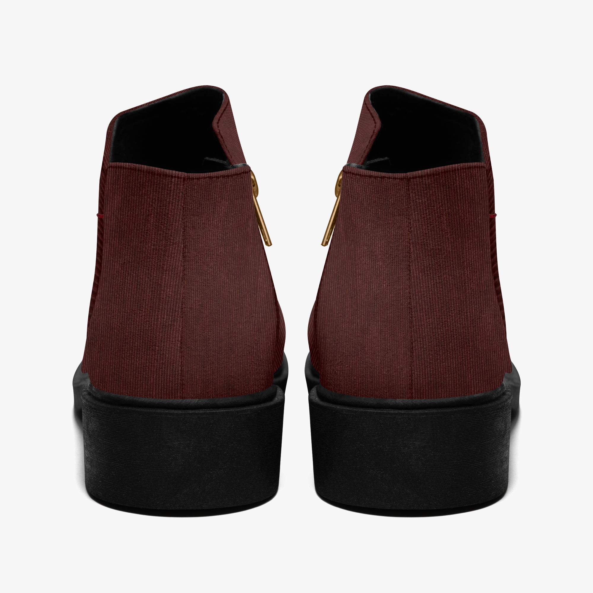 Pair of burgundy corduroy ankle boots with chunky black heels and visible gold zippers on the sides.