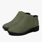 Olive green textured ankle boots with chunky black heels and side zipper closure.