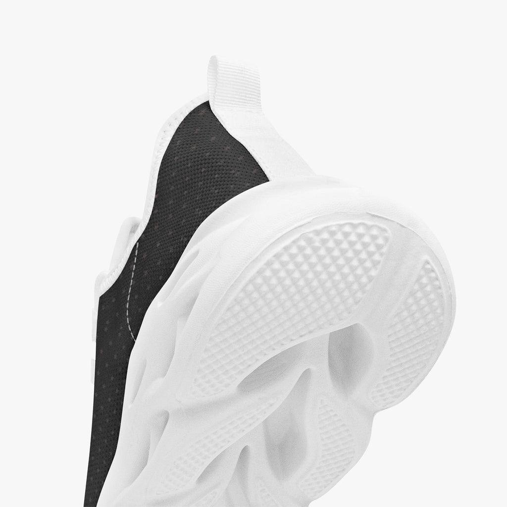 Black speckled knit sneakers with thick white textured soles and white heel tab.