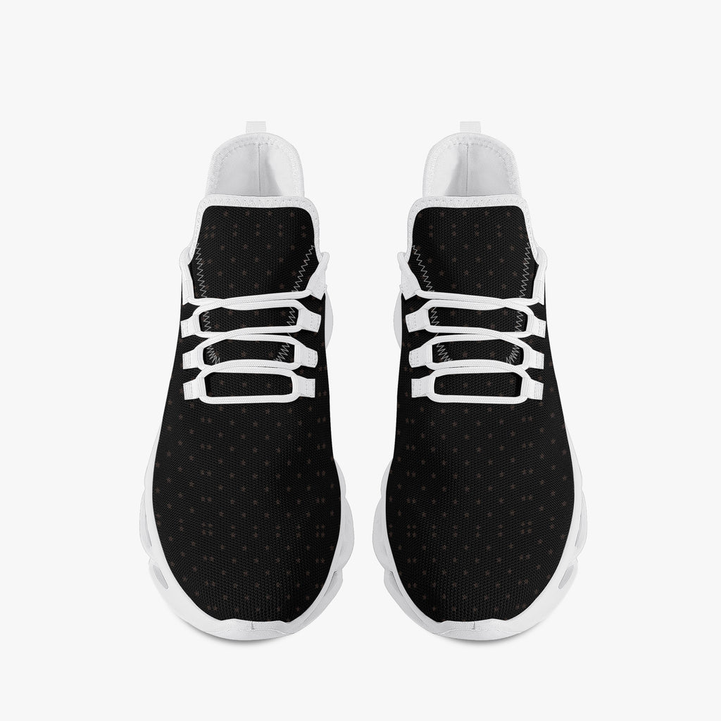 Black speckled knit sneakers with white laces and white rubber soles, viewed from above.