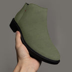 Olive green textured ankle boot with chunky black heel and side zipper.