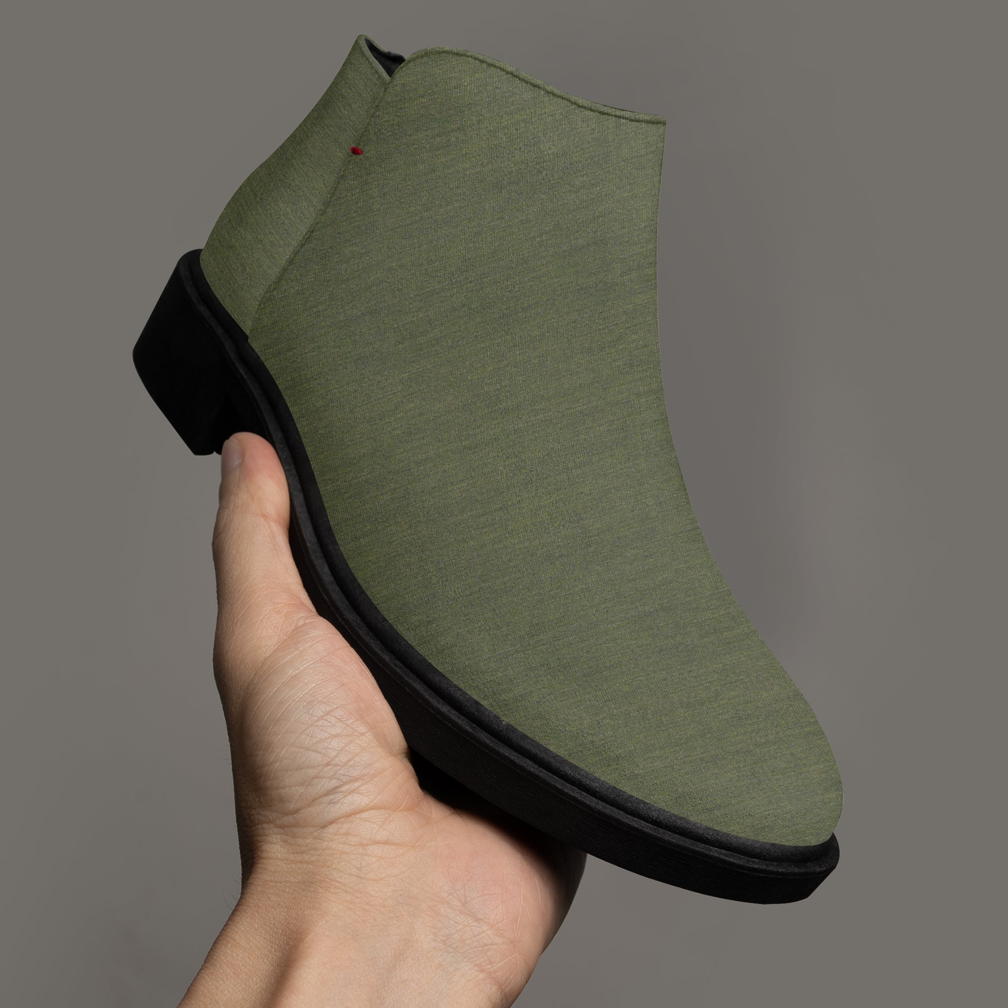 Olive green textured ankle boot with chunky black heel and side zipper.