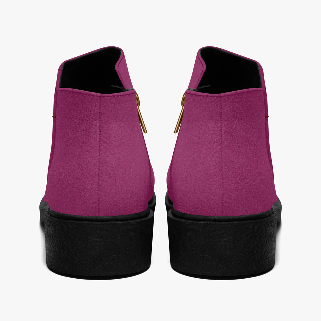 Magenta suede ankle boots with chunky black heels and gold zipper pull tabs, rear view.
