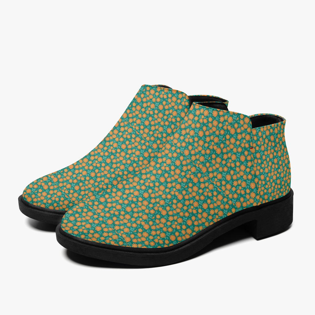 Teal ankle boots with orange floral print, black chunky heel, and side zipper.