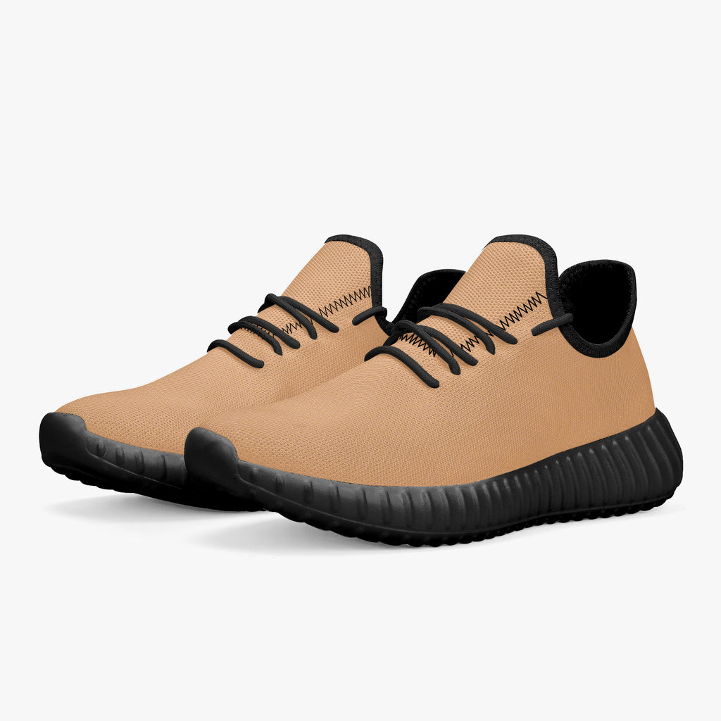 Beige knit low-top sneakers with black soles and black laces, breathable mesh design.