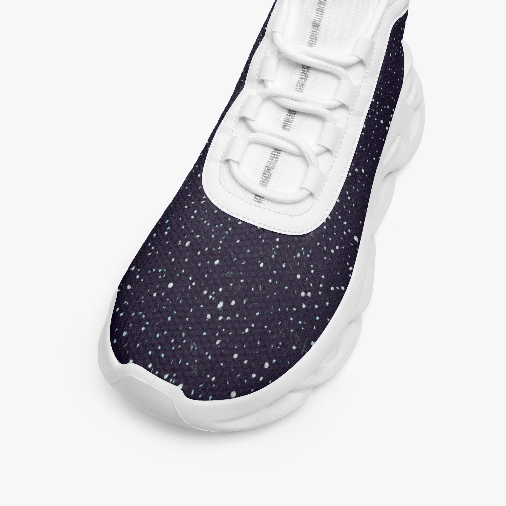 Black high-top sneakers with white speckle pattern, white mesh knit tongue, and thick white sole.