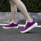 Low-top purple leather sneakers with white laces and thick white rubber soles on model feet.