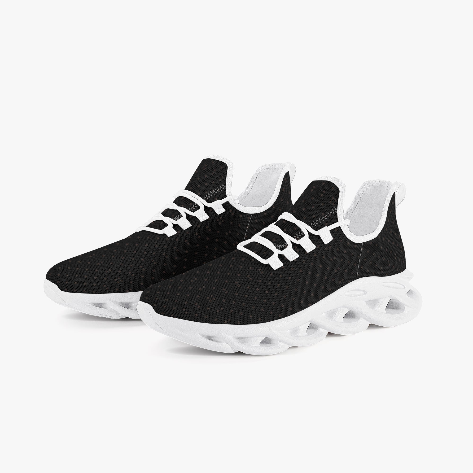 Black speckled knit sneakers with white sole and unique hollowed-out midsole design.
