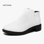 Modern white slip-on bootie with chunky black heel and subtle red accent stitch.