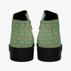 Teal ankle boots with orange floral print and chunky black heels, rear view with visible zippers.