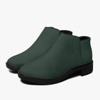 Dark green textured ankle boots with smooth black chunky heels and sleek rounded toes.